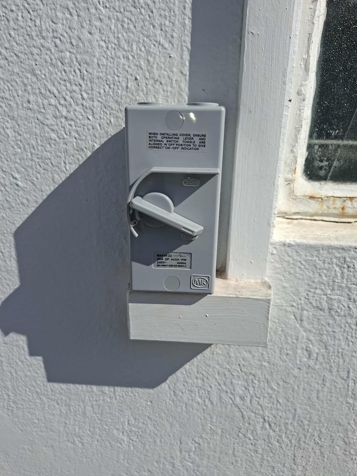 MK weatherproof isolator switch newly mounted on an exterior wall